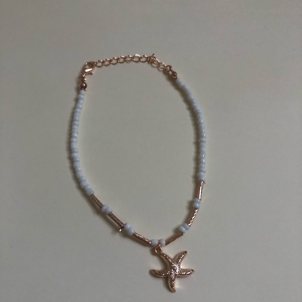 Costume bracelet with white beads and star charm